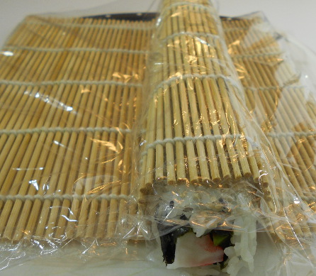 wrap bamboo mat around the sushi roll