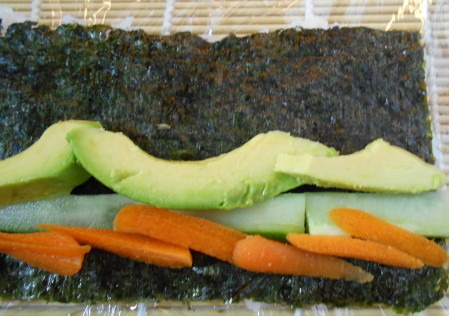 uramaki sushi roll with cuke and avocado, carrots